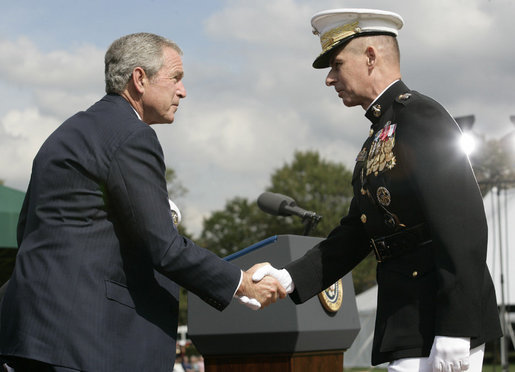 President George W. Bush and outgoing Joint Chiefs of Staff Chairman U.S. Marine General Peter Pace shake hands during the Armed Forces farewell tribute in honor of General Pace and the Armed Forces hail in honor of the new Joint Chiefs of Staff Chairman Navy Admiral Michael Mullen, Monday, October 1, 2007 at Fort Myer, Virginia. General Pace is retiring after serving two years as chairman and 40 years in the U.S. Marines. White House photo by Eric Draper