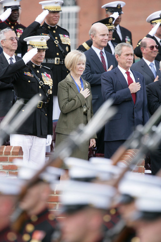 President George W. Bush stands with outgoing Joint Chiefs of Staff Chairman U.S. Marine General Peter Pace and Pace's wife, Lynne Pace, center, as troops pass in review during the Armed Forces farewell tribute in honor of General Pace and the Armed Forces hail in honor of the new Joint Chiefs of Staff Chairman Navy Admiral Michael Mullen, Monday, October 1, 2007 at Fort Myer, Virginia. White House photo by Chris Greenberg