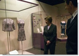 Mrs. Laura Bush looks at a dress worn by Jacqueline Kennedy during a tour of the exhibit First Ladies: Political Role and Public Image at the National Constitution Center Monday, Oct. 1, 2007, in Philadelphia. White House photo by Shealah Craighead