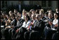 President George W. Bush joins the Rose Garden audience during a celebration Wednesday, Oct. 10, 2007, of Hispanic Heritage Month at the White House. Sitting with the President is Yamile Llanes Labrada, the wife of a political prisoner in Cuba, and Emilio Estefan. White House photo by Eric Draper