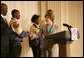 Mrs. Laura Bush is joined on stage by Ballou High School Marching Band Director Darrell Watson, left, as she greets band members Lewis Franklin, Rhia Hardman and Kenneth Horne, right, at the White House Thursday, Oct. 11, 2007, prior to a screening of Ballou: A Documentary Film, about the Washington, D.C. band’s inspiring accomplishments for the students and their school. White House photo by Shealah Craighead