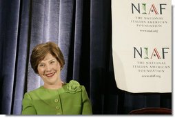 Mrs. Laura Bush smiles as she listens to an introduction by Dr. Ken Ciongoli , chairman of The National Italian American Foundation, during an education luncheon honoring Mrs. Bush with the NIAF Special Achievement Award in Literacy, Friday, Oct. 12, 2007 in Washington, D.C. In thanking the organization Mrs. Bush emphasized the many contributions that Italian-Americans have made in the education of our nation’s youth. White House photo by Shealah Craighead