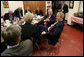 President George W. Bush participates in a lunch meeting with local business and civic leaders at the Whole Hog Cafe in Rogers, Ark., Monday, Oct. 15, 2007, speaking with Susan Barrett, left, president of Mercy Health System of Northwest Arkansas, Inc., and John A. White, Jr., chancellor of the University of Arkansas, right. White House photo by Eric Draper