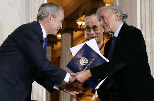 President George W. Bush, joined by The Dalai Lama, welcomes Nobel Peace Laureate Elie Wiesel, Wednesday, Oct. 17, 2007, to the ceremony at the U.S. Capitol in Washington, D.C., for the presentation of the Congressional Gold Medal to The Dalai Lama. White House photo by Chris Greenberg