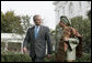 President George W. Bush speaks with President Ellen Johnson Sirleaf of the Republic of Liberia during a walk along the South Lawn driveway, Thursday, Oct. 18, 2007. White House photo by Joyce N. Boghosian