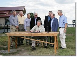 President George W. Bush signs an Executive Order to protect the striped bass and red drum fish populations Saturday, Oct. 20, 2007, at the Chesapeake Bay Maritime Museum in St. Michaels, Md. President Bush is joined during the signing by, from left, Michael Nussman, president of American Sportfishing Association; Brad Burns, president of Stripers Forever; David Pfeifer, president of Shimano America Corp.; Walter Fondren, chairman of Coastal Conservation Association; U.S. Secretary of Commerce Carlos Gutierrez; U.S. Rep. Wayne Gilchrest of Maryland and U.S. Secretary of Interior Dirk Kempthorne. White House photo by Eric Draper