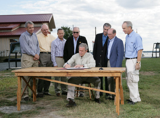 President George W. Bush signs an Executive Order to protect the striped bass and red drum fish populations Saturday, Oct. 20, 2007, at the Chesapeake Bay Maritime Museum in St. Michaels, Md. President Bush is joined during the signing by, from left, Michael Nussman, president of American Sportfishing Association; Brad Burns, president of Stripers Forever; David Pfeifer, president of Shimano America Corp.; Walter Fondren, chairman of Coastal Conservation Association; U.S. Secretary of Commerce Carlos Gutierrez; U.S. Rep. Wayne Gilchrest of Maryland and U.S. Secretary of Interior Dirk Kempthorne. White House photo by Eric Draper