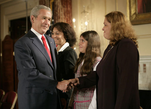 President George W. Bush greets his guests Marlenis Gonzalez, right, and her daughter Melissa, center, Wednesday, October 24, 2007, after his remarks on Cuba policy at the State Department in Washington, D.C. Melissa's father, Jorge Luis Gonzalez Tanquero is currently being held in a Cuban prison after being arrested for crimes against the regime. White House photo by Eric Draper