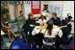 Mrs. Laura Bush shakes hands with student Taylor McIntyre, during her visit with students at the Good Shepherd Nativity Mission School, Thursday, Nov. 1, 2007 in New Orleans, a Helping America's Youth visit with Big Brother and Big Sisters of Southeast Louisiana. Captain Richard T. Douget, second from left, is a Big Brother to Taylor McIntyre. White House photo by Shealah Craighead