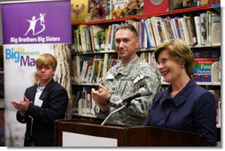 Mrs. Laura Bush is applauded during her address to students, faculty and guests at the Good Shepherd Nativity Mission School, Thursday, Nov. 1, 2007 in New Orleans, during a Helping America's Youth visit with Big Brother and Big Sisters of Southeast Louisiana. Mrs. Bush spoke about the importance of adults as positive role models in young children's lives. Student Taylor McIntyre is seen at left, joined by his Big Brother Captain Richard T. Douget. White House photo by Shealah Craighead