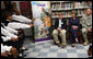 Mrs. Laura Bush listens to the student choir perform at the Good Shepherd Nativity Mission School, Thursday, Nov. 1, 2007 in New Orleans, during a Helping America's Youth visit with Big Brothers and Big Sisters of Southeast Louisiana. Mrs. Bush is joined by student Taylor McIntyre, left, and his Big Brother Captain Richard T. Douget. White House photo by Shealah Craighead