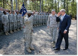 President George W. Bush salutes as he acknowledges members of the 260th Brigade during his visit to Fort Jackson in Columbia, S.C. Fort Jackson is the largest and most active Initial Entry Training Center in the U.S. Army, training more than 50 percent of all soldiers enter the Army each year. With him is Brig. Gen James Schwitter, Commanding General of the base. White House photo by Eric Draper