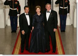 President George W. Bush and Mrs. Laura Bush stand with President Nicolas Sarkozy of France on the North Portico of the White House after his arrival for dinner Tuesday, Nov. 6, 2007. White House photo by Chris Greenberg