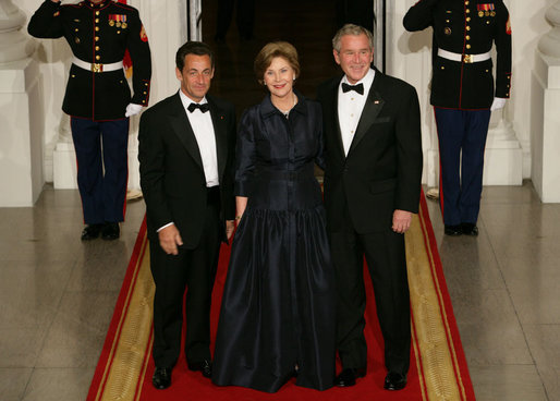 President George W. Bush and Mrs. Laura Bush stand with President Nicolas Sarkozy of France on the North Portico of the White House after his arrival for dinner Tuesday, Nov. 6, 2007. White House photo by Chris Greenberg