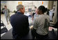 President George W. Bush speaks with a wounded soldier during his visit Thursday, Nov. 8, 2007 to the physical therapy and training area at the Center for The Intrepid at the Brooke Army Medical Center in San Antonio, Texas. White House photo by Eric Draper