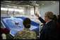 President George W. Bush gives the thumbs up during a Flowrider demonstration, Thursday, Nov. 8, 2007 at the Center for The Intrepid at the Brooke Army Medical Center in San Antonio, Texas. Wounded soldiers use the wave simulation activity to improve balance, coordination and strength. White House photo by Eric Draper