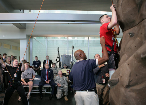 President George W. Bush, left, watches as double amputee Lance Cpl. Matt Bradford, who is also blind, climbs a wall, during President Bush’s visit Thursday, Nov. 8, 2007 to the physical therapy and training area for wounded soldiers at the Center for The Intrepid at the Brooke Army Medical Center in San Antonio, Texas. White House photo by Eric Draper