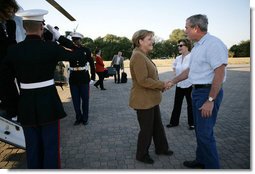 President George W. Bush and Mrs. Laura Bush welcome German Chancellor Angela Merkel and her husband Dr. Joachim Sauer as they arrive via helicopter to the Bush ranch in Crawford, Texas, Friday, Nov. 9, 2007. White House photo by Eric Draper