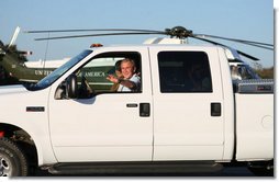 President George W. Bush waves as he drives German Chancellor Angela Merkel, Mrs. Laura Bush and Merkel’s husband, Dr. Joachim Sauer, following the Merkel’s arrival to the Bush ranch in Crawford, Texas, Friday, Nov. 9, 2007. White House photo by Shealah Craighead