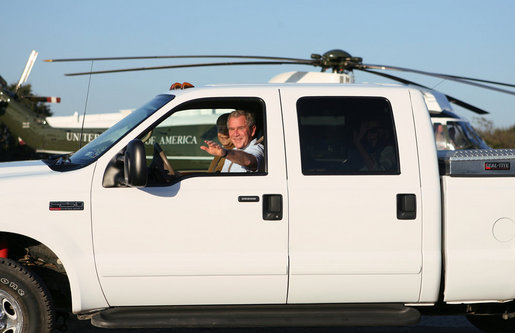 President George W. Bush waves as he drives German Chancellor Angela Merkel, Mrs. Laura Bush and Merkel’s husband, Dr. Joachim Sauer, following the Merkel’s arrival to the Bush ranch in Crawford, Texas, Friday, Nov. 9, 2007. White House photo by Shealah Craighead