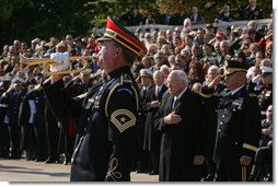 An U.S. Army Band bugler plays Taps during a wreath-laying ceremony at the Tomb of the Unknown Soldier, Sunday, Nov. 11, 2007, at Arlington National Cemetery in Arlington, Va. White House photo by David Bohrer