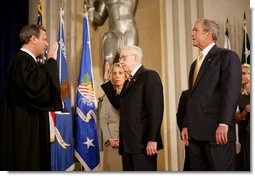 President George W. Bush attends the swearing in of Attorney General Michael Mukasey Wednesday, Nov. 14, 2007, at the U.S. Department of Justice in Washington, D.C. Chief Justice of the United States John Roberts conducted the ceremony."The Attorney General must run the world's largest law firm, and the central agency for enforcement of our federal laws," said President Bush. "He must aggressively prosecute gun criminals and drug dealers, hold corporate wrongdoers to account, protect victims of child abuse and domestic violence, and uphold the civil rights of every American." White House photo by Eric Draper