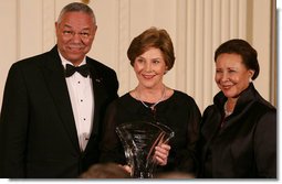 Mrs. Laura Bush is joined on stage by former Secretary of State Colin Powell and his wife, Alma Powell, as they present Mrs. Bush with a National Promise of America Founders Award, Tuesday evening, Nov. 13, 2007, during a social dinner to celebrate the tenth anniversary of America's Promise-The Alliance for Youth. White House photo by Joyce N. Boghosian