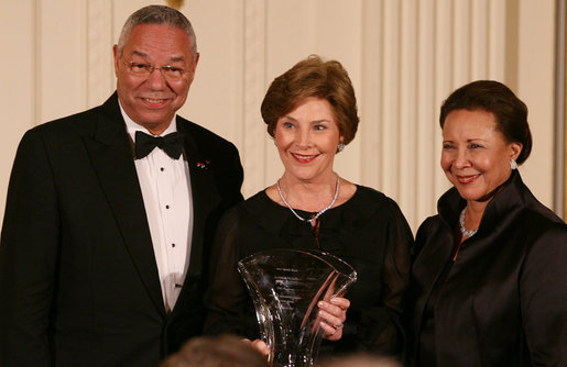 Mrs. Laura Bush is joined on stage by former Secretary of State Colin Powell and his wife, Alma Powell, as they present Mrs. Bush with a National Promise of America Founders Award, Tuesday evening, Nov. 13, 2007, during a social dinner to celebrate the tenth anniversary of America's Promise-The Alliance for Youth. White House photo by Joyce N. Boghosian