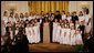 President George W. Bush and Mrs. Laura Bush join singer Melinda Doolittle, center, and members of the World Children's Choir on stage Tuesday evening, Nov. 13, 2007 in the East Room of the White House, during the social dinner in honor of the tenth anniversary of America's Promise-The Alliance for Youth. White House photo by Joyce N. Boghosian