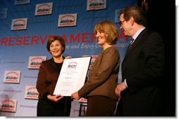 Mrs. Laura Bush presents fifth grade history teacher Maureen Festi, center, who teaches at Stafford Elementary School in Stafford, Conn., with the 2007 Preserve America National History Teacher of the Year Award at the Museum of the City of New York, Friday, Nov. 16, 2007 in New York. Dr. James Basker, president of the Gilder Lehrman Institute for American History looks on. White House photo by Shealah Craighead