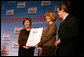 Mrs. Laura Bush presents fifth grade history teacher Maureen Festi, center, who teaches at Stafford Elementary School in Stafford, Conn., with the 2007 Preserve America National History Teacher of the Year Award at the Museum of the City of New York, Friday, Nov. 16, 2007 in New York. Dr. James Basker, president of the Gilder Lehrman Institute for American History looks on. White House photo by Shealah Craighead