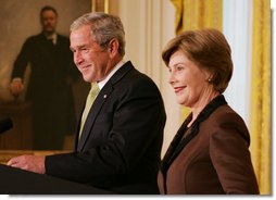 President George W. Bush is joined by Mrs. Laura Bush in the East Room of the White House, Friday, Nov. 16, 2007, in an address to invited guests in celebration of National Adoption Day. President Bush, in speaking to parents and children, said he was "So thankful that the parents and children here today have found the gift of one another. And I encourage our citizens across the land to explore adoption, look into the joys of adoption, and provide love for somebody who needs it." White House photo by Joyce N. Boghosian