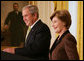 President George W. Bush is joined by Mrs. Laura Bush in the East Room of the White House, Friday, Nov. 16, 2007, in an address to invited guests in celebration of National Adoption Day. President Bush, in speaking to parents and children, said he was "So thankful that the parents and children here today have found the gift of one another. And I encourage our citizens across the land to explore adoption, look into the joys of adoption, and provide love for somebody who needs it." White House photo by Joyce N. Boghosian