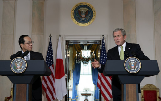 As Prime Minister Yasuo Fukuda of Japan looks on, President George W. Bush makes remarks during a joint statement Friday, Nov. 16, 2007, in the Cross Hall of the White House. Said the President, "The alliance between our two countries is rooted deeply in our strong commitments to freedom and democracy." White House photo by Chris Greenberg