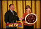 Mrs. Laura Bush and U.S. Mint Director Ed Moy hold up the Dolley Madison Gold Coin Monday, Nov. 19, 2007, in the East Room. "Today, we're paying tribute to an amazing First Lady, and an extraordinary woman, with the Dolley Madison Gold Coin," said Mrs. Bush. "Over the last year, since the U.S. Mint launched the First Ladies series, these coins have been extremely popular: The likenesses of Martha Washington, Abigail Adams, and Jefferson's Lady Liberty sold out within hours of their release. Their appeal reflects the enthusiasm of America's coin collectors, the public's fascination with American history, and Americans' interest in our remarkable First Ladies." White House photo by Joyce N. Boghosian