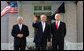 President George W. Bush waves to photographers as he stands with Palestinian President Mahmoud Abbas, left, and Prime Minister Ehud Olmert Tuesday, Nov. 27, 2007, at the Annapolis Conference in Annapolis, Maryland. White House photo by Chris Greenberg