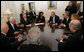 President George W. Bush shares a light moment with Palestinian President Mahmoud Abbas, second from left, Israel's Prime Minister Ehud Olmert, lower right during a meeting Tuesday, Nov. 27, 2007, during the Annapolis Conference in Annapolis, Maryland. With them are senior officials from Israel, Palestine and the United States, including National Security Adviser Stephen Hadley, third from left, and United States Secretary of State Condoleezza Rice. White House photo by Chris Greenberg