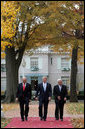 President George W. Bush is flanked by Prime Minister Ehud Olmert, left, of Israel, and President Mahmoud Abbas of the Palestinian Authority as they walk Tuesday, Nov. 27, 2007, from the Buchanan House on the grounds of the U.S. Naval Academy in Annapolis, Maryland, to Bancroft Hall during the Annapolis Conference. The leaders agreed to immediately resume Mideast peace talks. White House photo by Chris Greenberg