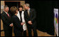 President George W. Bush shares a moment with Nebraska Gov. Dave Heineman, Andrea Skolkin and Kristine McVea, in lab coat, before his tour Wednesday, Dec. 5, 2007, of the OneWorld Community Health Centers Inc. in Omaha. White House photo by Chris Greenberg