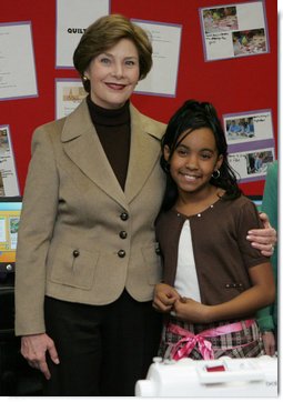 Mrs. Laura Bush embraces 10-year-old Taylor Rice, whose father is currently serving overseas in the Army Reserves, during a visit to the Learning Center at Andrews Air Force Base in Maryland, Wednesday, Dec. 5, 2007, where Mrs. Bush participated is a roundtable discussion on the special needs of military youth and families. White House photo by Joyce N. Boghosian