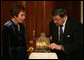 A Menorah belonging to the great-grandfather of Daniel Pearl is lit by Judea and Ruth Pearl, his parents, during festivities Monday, Dec. 10, 2007, in the Grand Foyer of the White House. Said the President of the slain journalist, "His only crime was being a Jewish American -- something Daniel Pearl would never deny. Daniel's memory remains close to our hearts. By honoring Daniel, we are given the opportunity to bring forth hope from the darkness of tragedy-- and that is a miracle worth celebrating during the Festival of Lights." White House photo by Joyce N. Boghosian