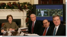 Mrs. Laura Bush is joined by Jim Jeffrey, Assistant to the President and Deputy National Security Advisor; Elliot Abrams, Deputy National Security Advisor for Global Democracy Strategy, and Dennis Wilder, Special Assistant to the President and Senior Director for East Asian Affairs, as she participates in a video conference on Burma in recognition of International Human Rights Day Monday, Dec. 10, 2007, in the Roosevelt Room of the White House. Speaking via video are U.S. Ambassador to Thailand Skip Boyce and Dr. Cynthia Maung, Founder and Director of the Mae Tao Clinic in Mae Sot,Thailand. White House photo by Chris Greenberg