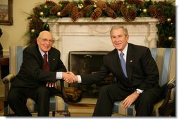 President George W. Bush and President Giorgio Napolitano exchange handshakes during the Italian leader's visit Tuesday, Dec. 11, 2007, to the White House. President Bush told his counterpart, "It's my honor to welcome you. Bilateral relations with the United States and Italy are very good. We have a lot of interchange between our countries, with business as well as travel." White House photo by Eric Draper