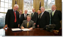 President George W. Bush signs into law H.R. 1429, the Improving Head Start for School Readiness Act of 2007, in the Oval Office Wednesday, Dec. 12, 2007. Members of Congress looking on are, from left: California Rep. George Miller; Michigan Rep. Dale Kildee; Sen. Ted Kennedy, D-Mass.; Delaware Rep. Mike Castle; Sen. Lamar Alexander, R-Tenn.; Sen. Mike Enzi, R-Wyo., and California Rep. Buck McKeon. White House photo by Chris Greenberg