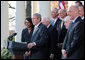 President George W. Bush, joined by Vice President Dick Cheney and members of his Cabinet, speaks with reporters in the Rose Garden, Friday, Dec. 14, 2007, where President Bush congratulated the Senate for passing a good energy bill, and urged Congress to move forward with spending legislation to fund the day to day operations of the federal government. President Bush also said he hoped those members of the press who attended a White House press reception Thursday evening had a good time, and joked that some silverware might be missing. White House photo by Eric Draper