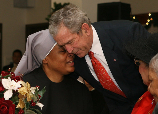 President George W. Bush shares a moment with a staff member at the Little Sisters of the Poor in Washington, D.C., Tuesday, Dec. 18, 2007, during his visit with Mrs. Laura Bush to the facility that provides nursing and assisted-living services to elderly people of lesser means. White House photo by Shealah Craighead