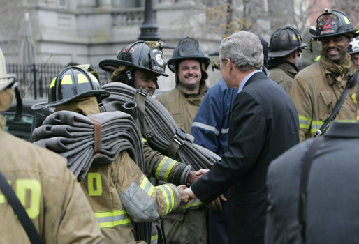 President George W. Bush shakes the hands of Washington, D.C. firefighters Wednesday, Dec. 19, 2007, after they battled a morning blaze at the Eisenhower Executive Office Building on the White House complex. White House photo by Chris Greenberg