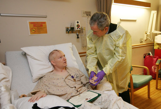 President George W. Bush visits with U.S. Army Capt. Patrick J. Horan of West Springfield, Va., at the National Naval Medical Center in Bethesda, Md., Wednesday, Dec. 19, 2007, after awarding Horan a Purple Heart medal and citation. Captain Horan is recovering from a head injury sustained in Operation Iraqi Freedom. White House photo by Joyce N. Boghosian