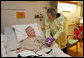 President George W. Bush visits with U.S. Army Capt. Patrick J. Horan of West Springfield, Va., at the National Naval Medical Center in Bethesda, Md., Wednesday, Dec. 19, 2007, after awarding Horan a Purple Heart medal and citation. Captain Horan is recovering from a head injury sustained in Operation Iraqi Freedom. White House photo by Joyce N. Boghosian