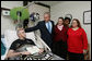 President George W. Bush visits with U.S. Army Sgt. John Wayne Cornell of Lansing, Mich., after presenting him with a Purple Heart Thursday, Dec. 20, 2007, during a visit to Walter Reed Army Medical Center in Washington, D.C., where he is recovering from injuries suffered in Operation Iraqi Freedom. With them are Sgt. Cornell's wife, Dee, and mother-in-law Diane Elaine Galloway. White House photo by Joyce N. Boghosian